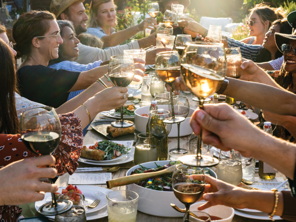 Little City Farm dinner attendees toasting wine glasses