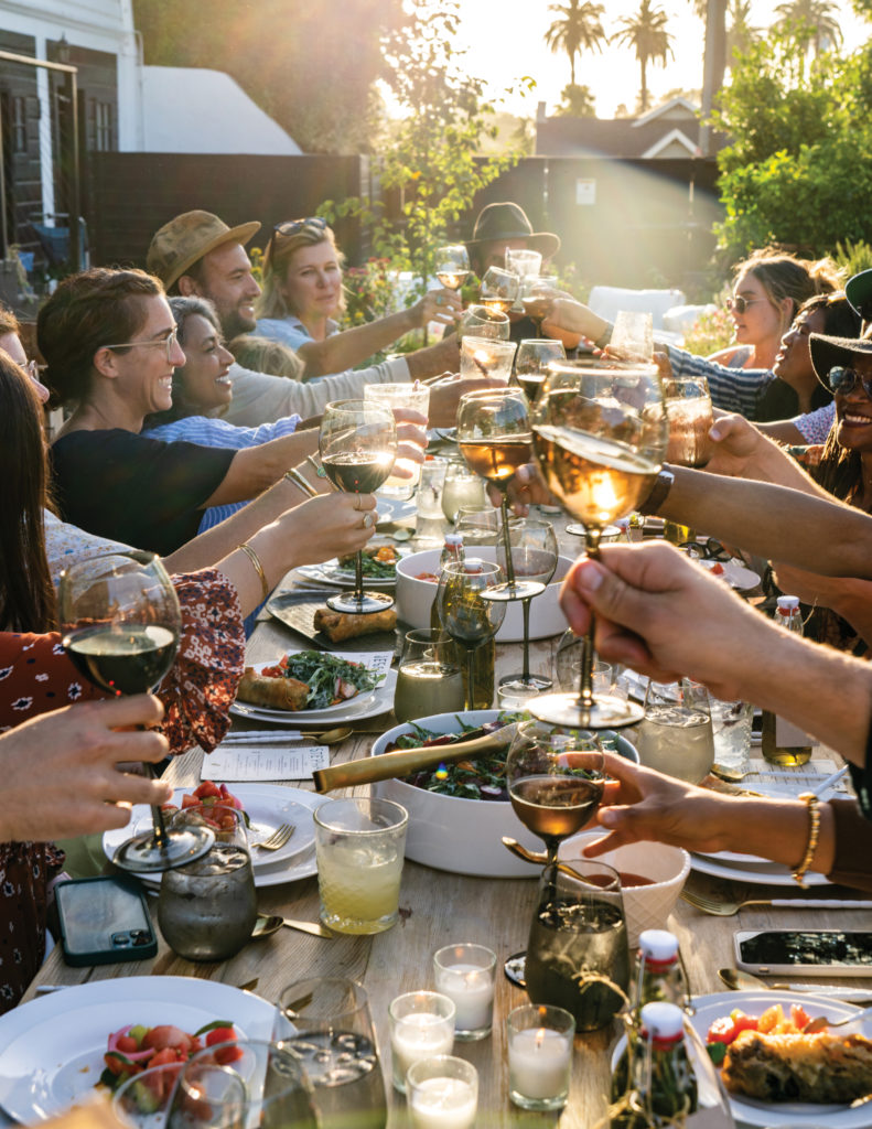 Little City Farm dinner attendees toasting wine glasses