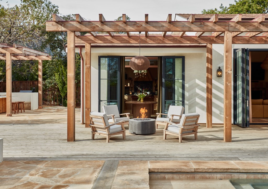 Patio with a fire pit and four chairs
