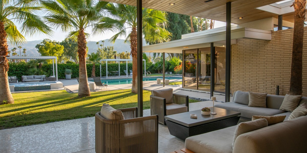 Patio with a seating area overlooking a mid-century pool