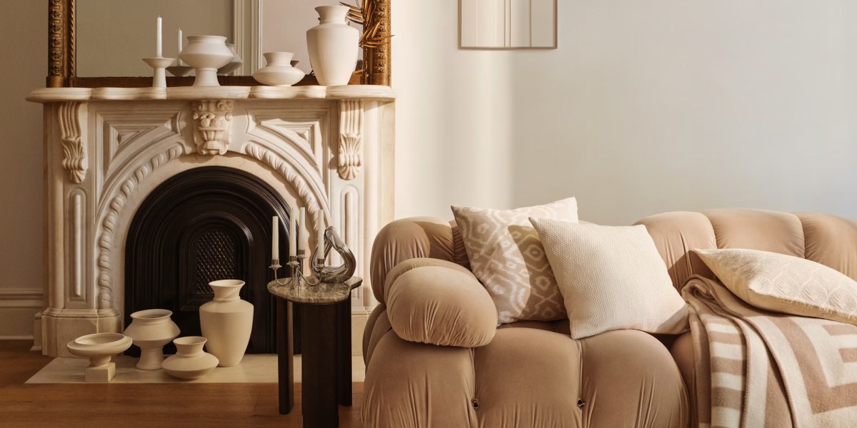 Cream and beige living room with a couch and fireplace accented with several vases