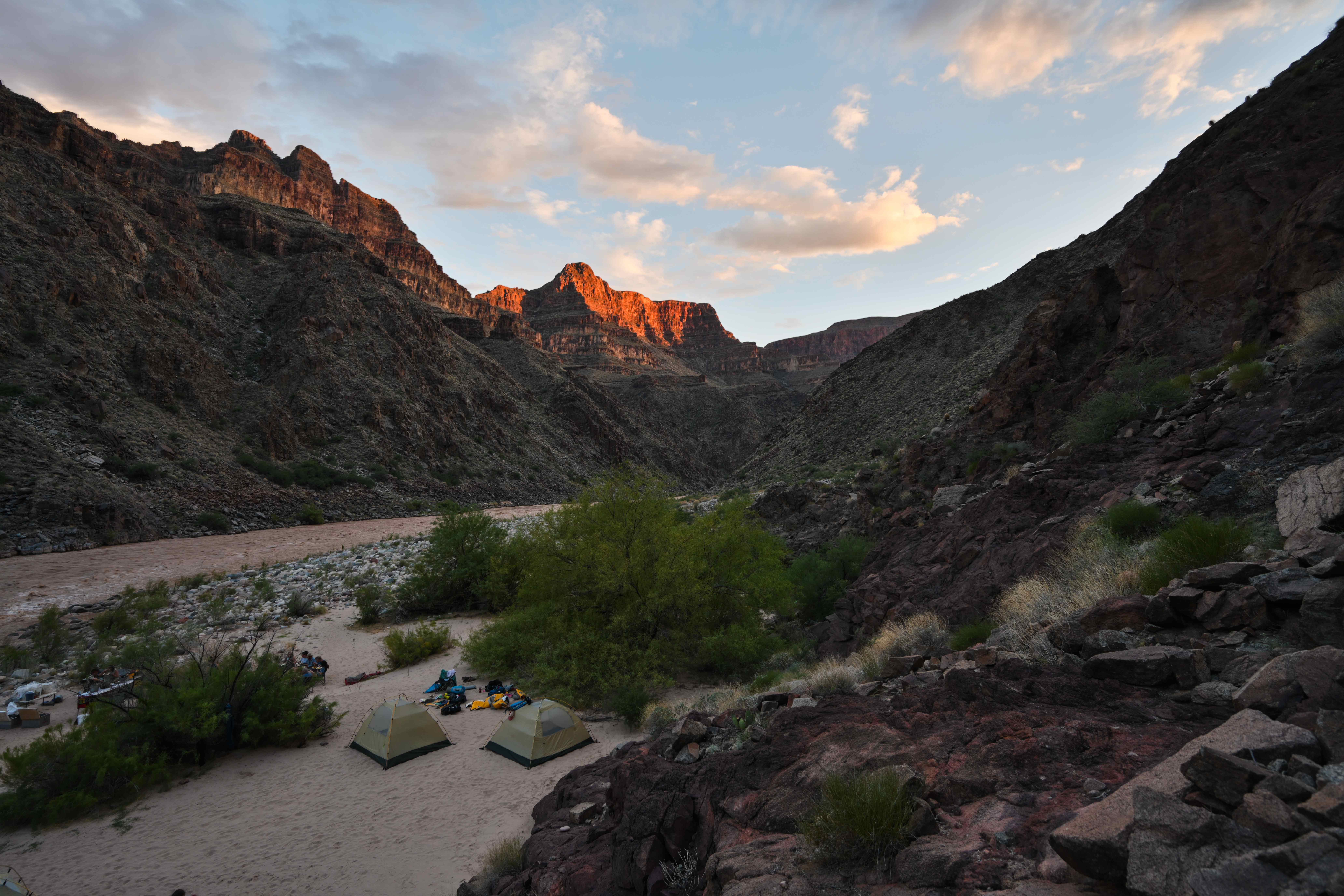 a-sandy-beach-camp-along-the-colorado-river-at-sunset