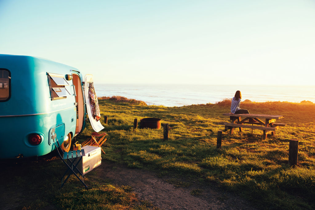 Airstream/RV at camp with picnic table and coastal view