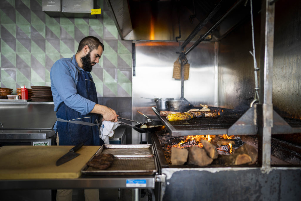 Roberto Centeno works the grill at Bacanora restaurant