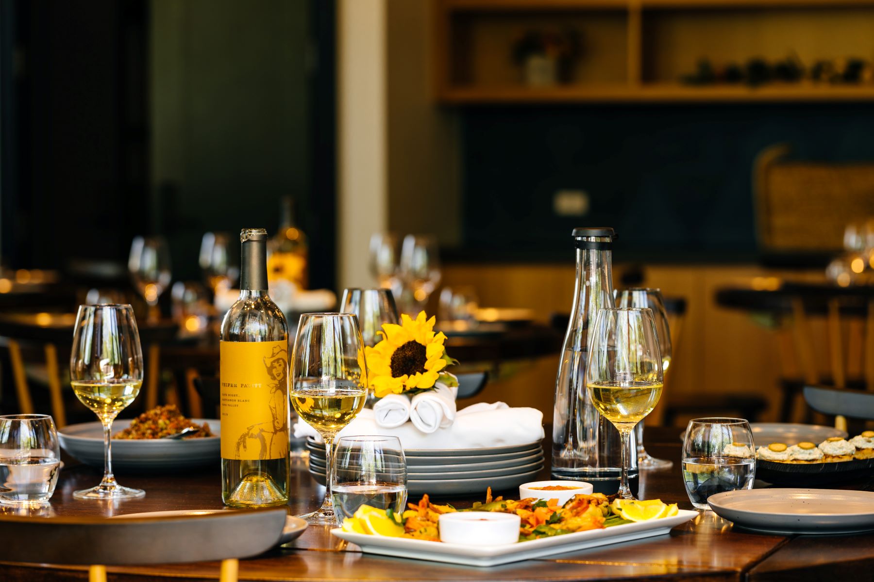 close-up-of-social-table-setting-with-appertizers-wine-1