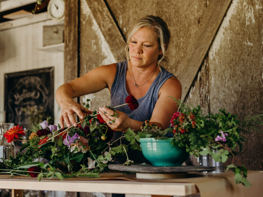 Beth Syphers arranges flowers in her studio, harvested from her farm.
