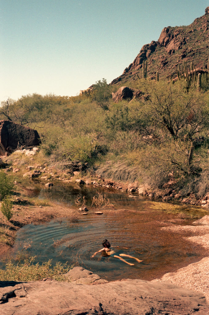 Man in swimming hole in the desert