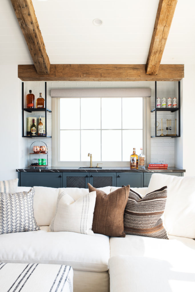 Manhattan Beach home tour by HMS Interiors bar with dark blue and black marble.