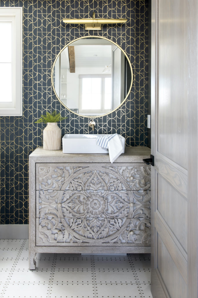 Manhattan Beach home tour by HMS Interiors bathroom with dark blue and gold wallpaper.