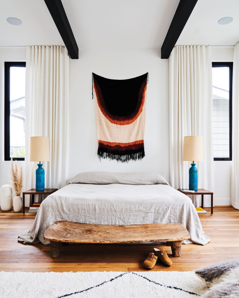 Newport Beach home bedroom with nightstands and tapestry