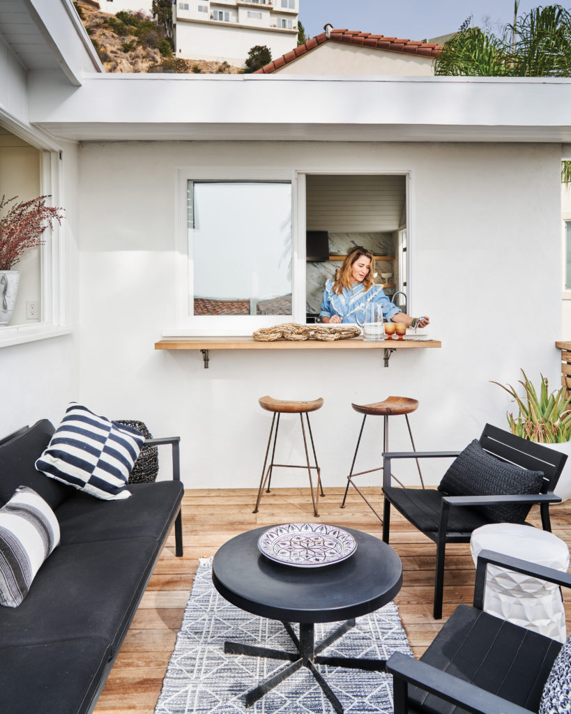 Tess Sanchez at pass-through window on deck