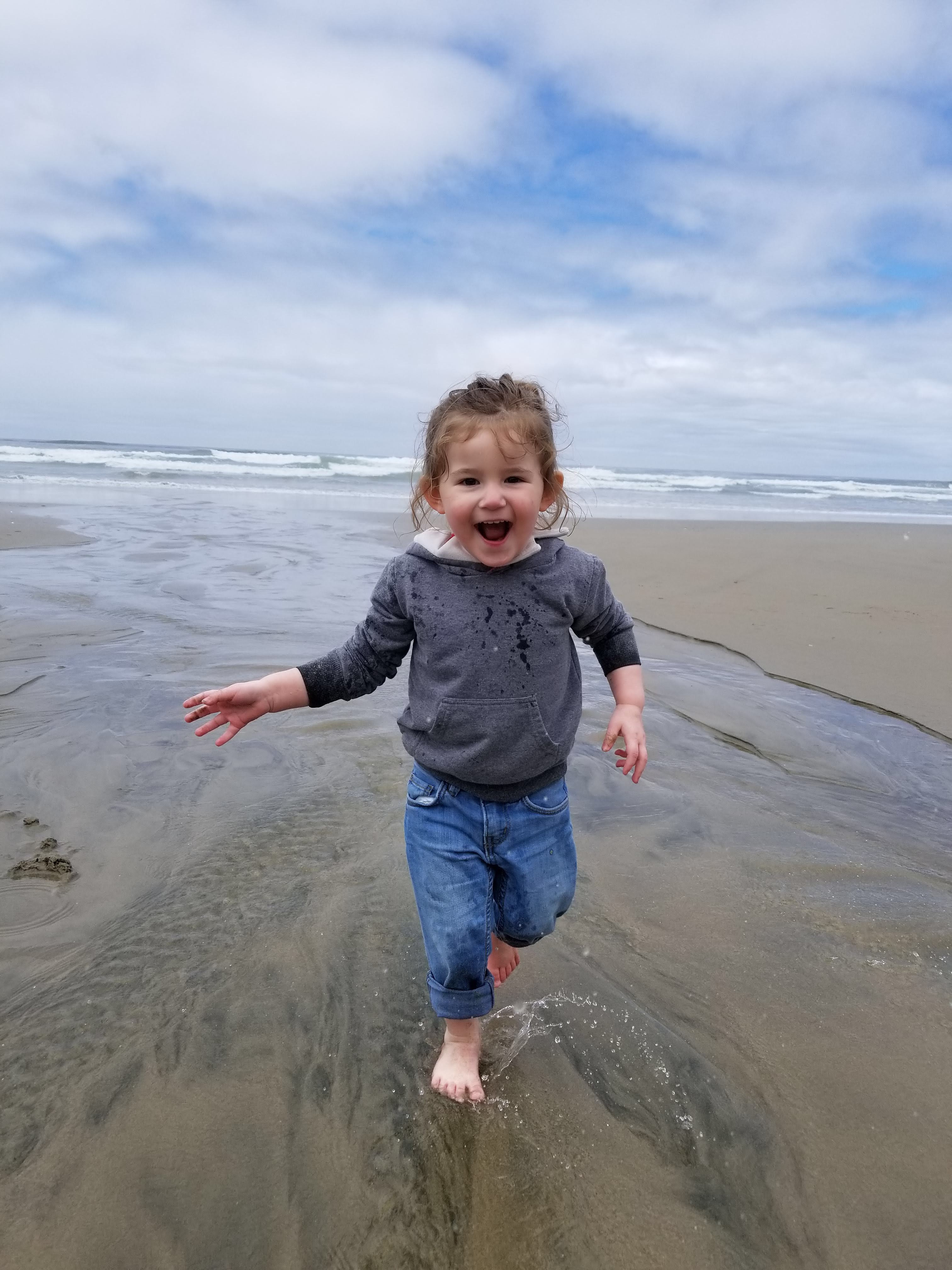 little-girl-running-beach-stream