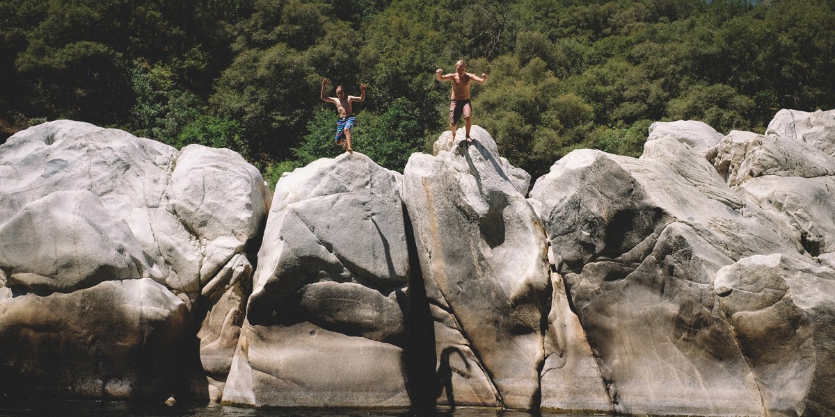 Two Boys Jump from Boulders at the Yuba River