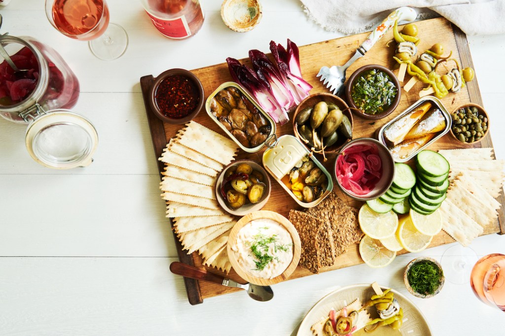 Forget Charcuterie, Cheese, and Butter Boards—The Tinned Fish Board Is the Tastiest, Trendiest Way to Entertain