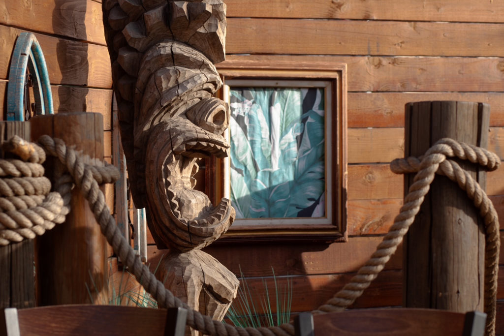 Tiki statue on patio of Tropicali restaurant