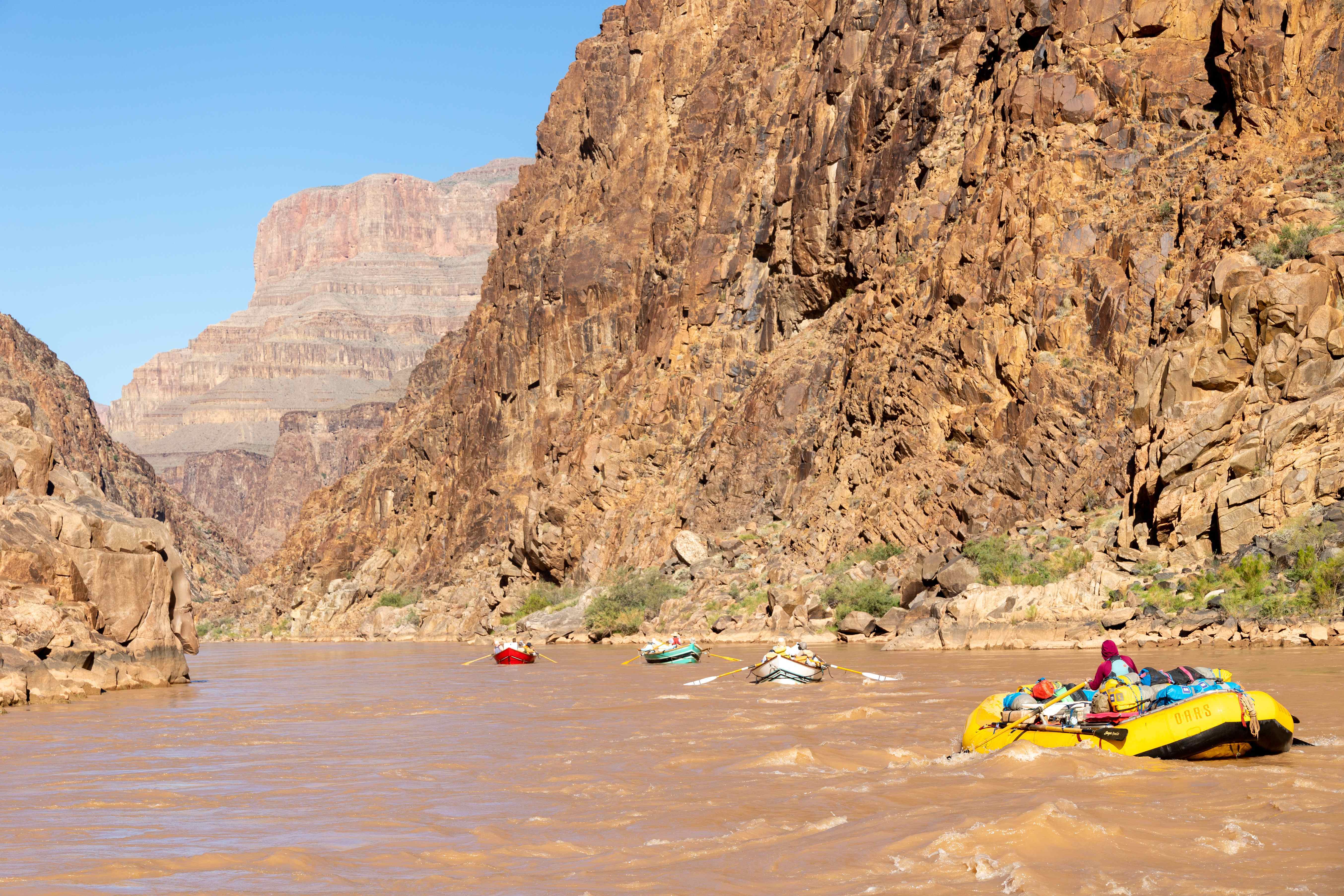 a-trio-of-oars-dories-and-a-raft-float-down-the-final-majestic-stretch-of-the-lower-grand-canyon