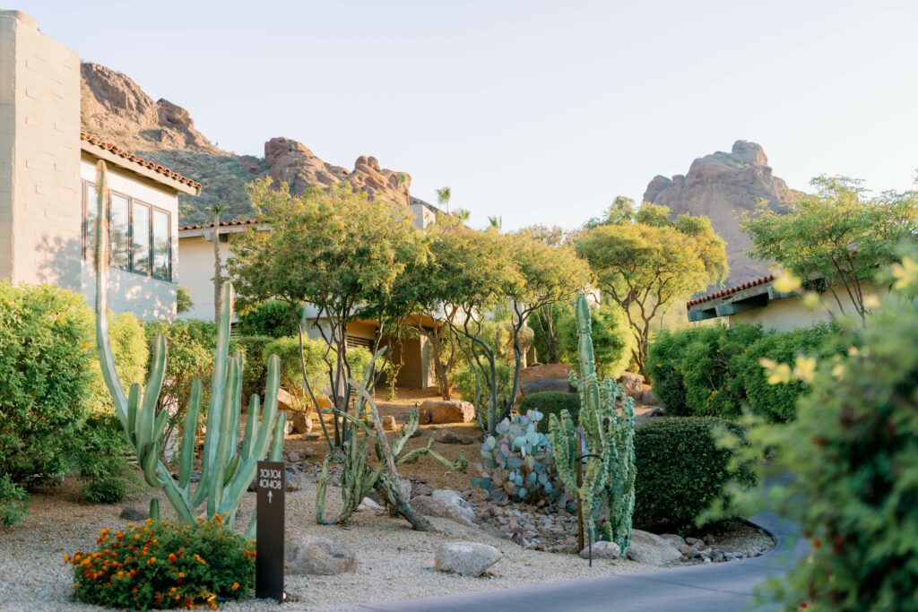 The exterior of a resort tucked into a desert landscape.