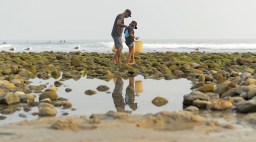 Volunteers pick up trash along the coastline in Santa Monica with Heal the Bay