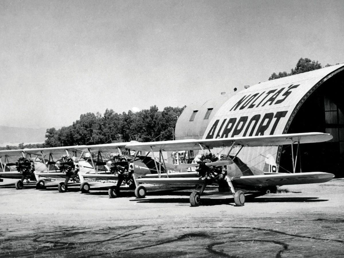 Biplane lineup in front of hanger