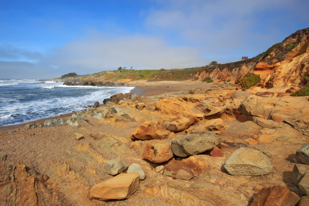 Pebble Beach and Tafoni formations in Pigeon Point formation sandstone at Bean Hollow State Beach in San Mateo County, California.