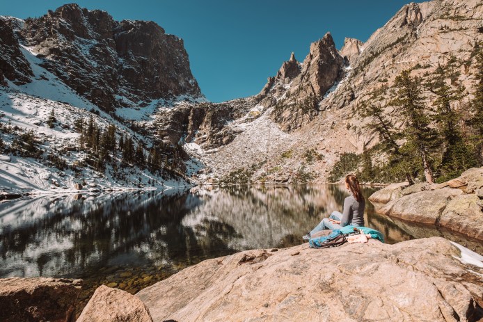 Woman near Emerald Lake at autumn in Rocky Mountain National Park in Colorado.