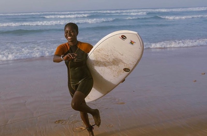 Woman on Beach with Surfboard