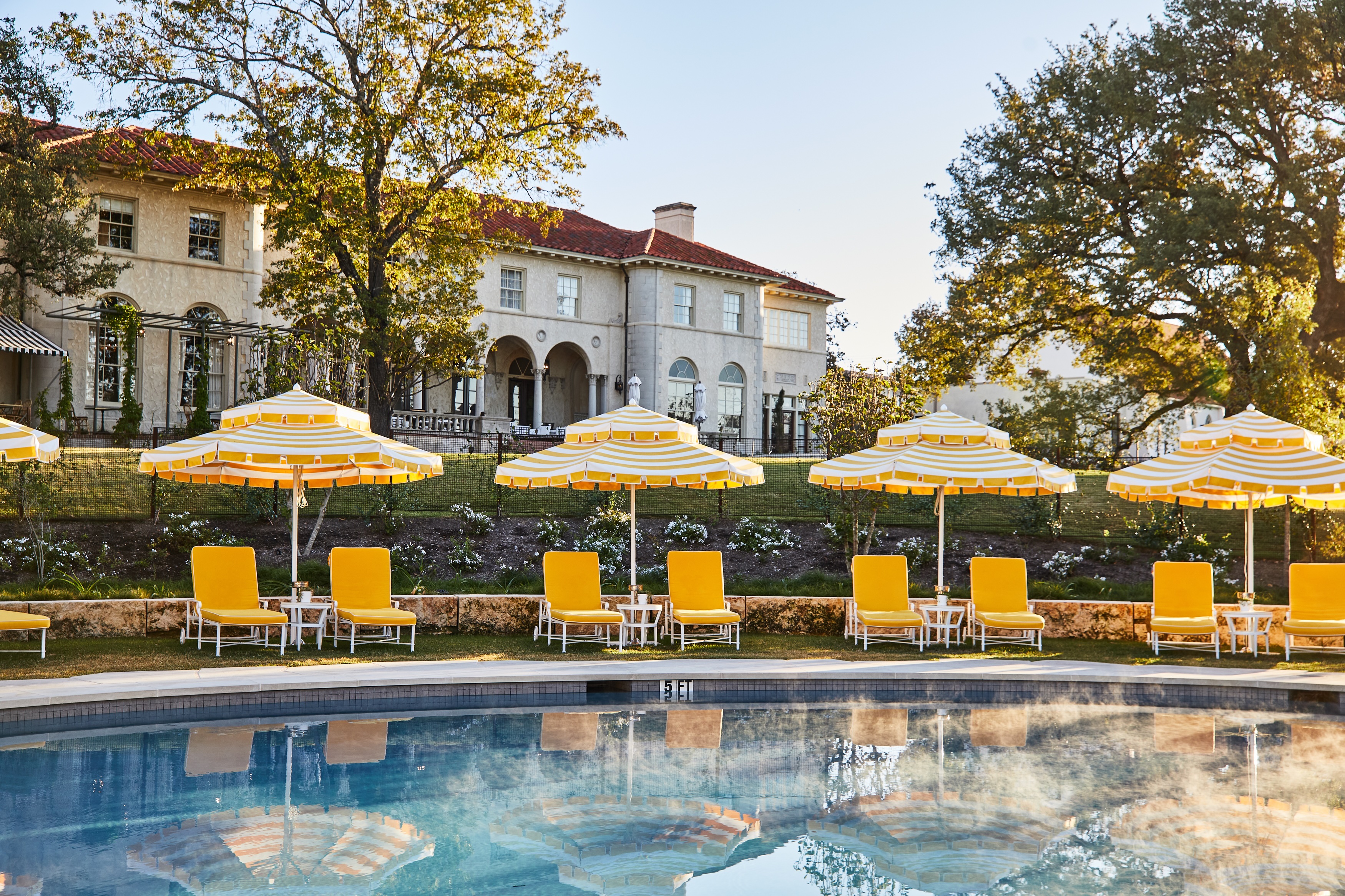 unwind-and-relax-by-the-pool-beneath-the-beautiful-estate-complete-with-drinks-and-bites-from-the-mansion