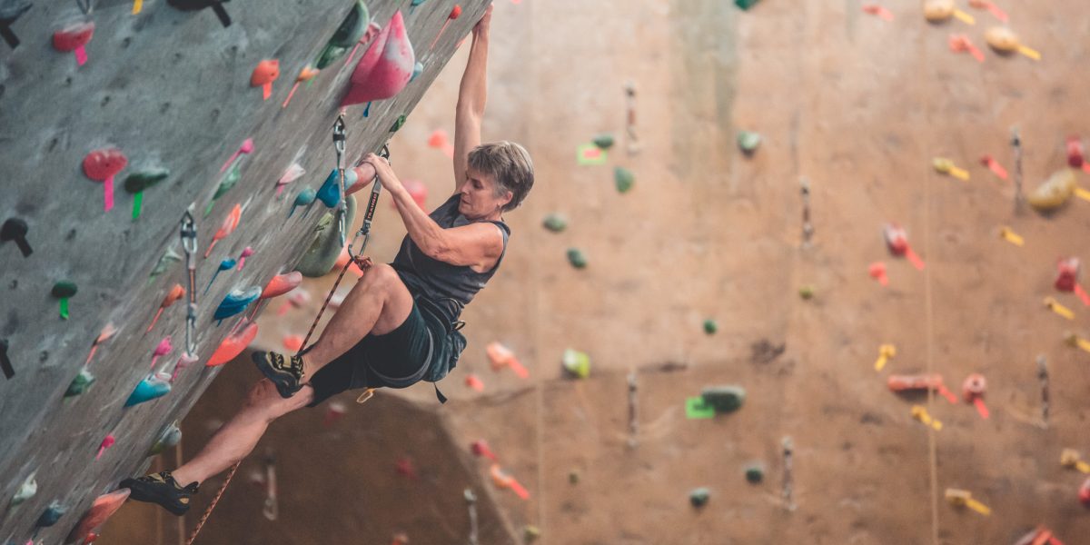 Climber scales a rock wall.