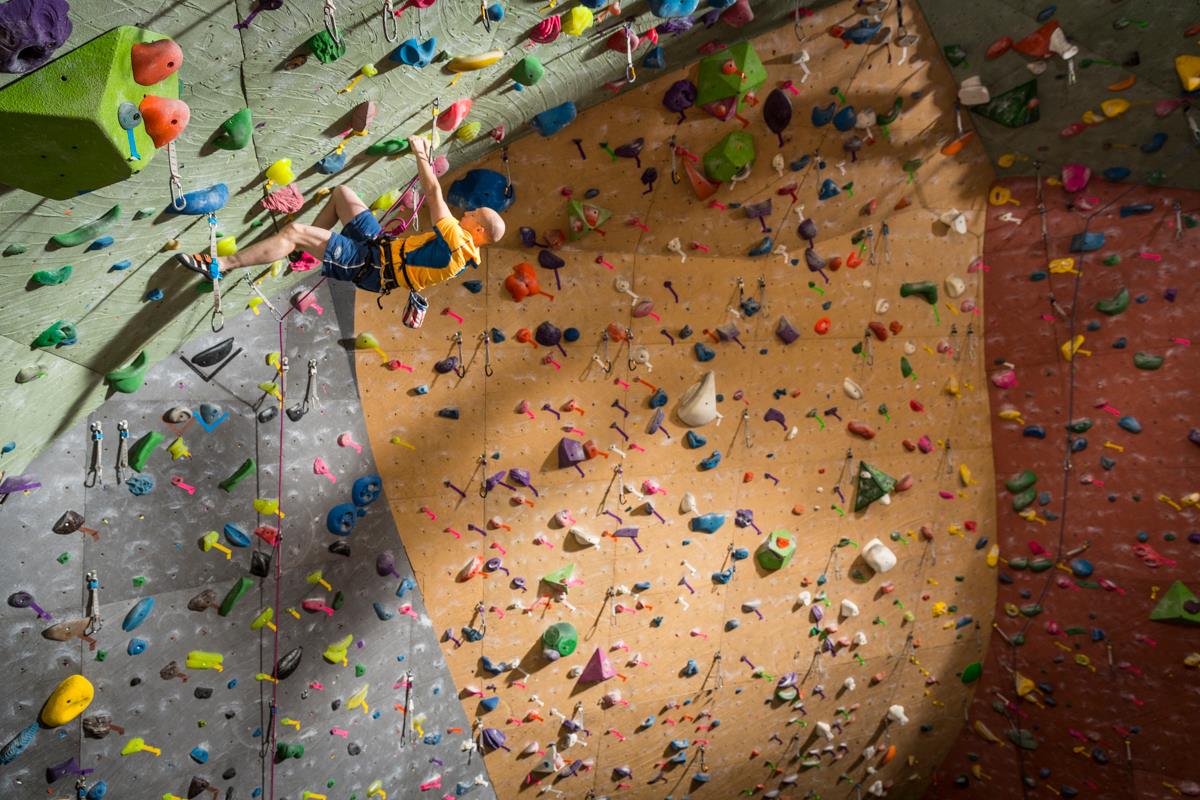 Climber scales a rock wall.