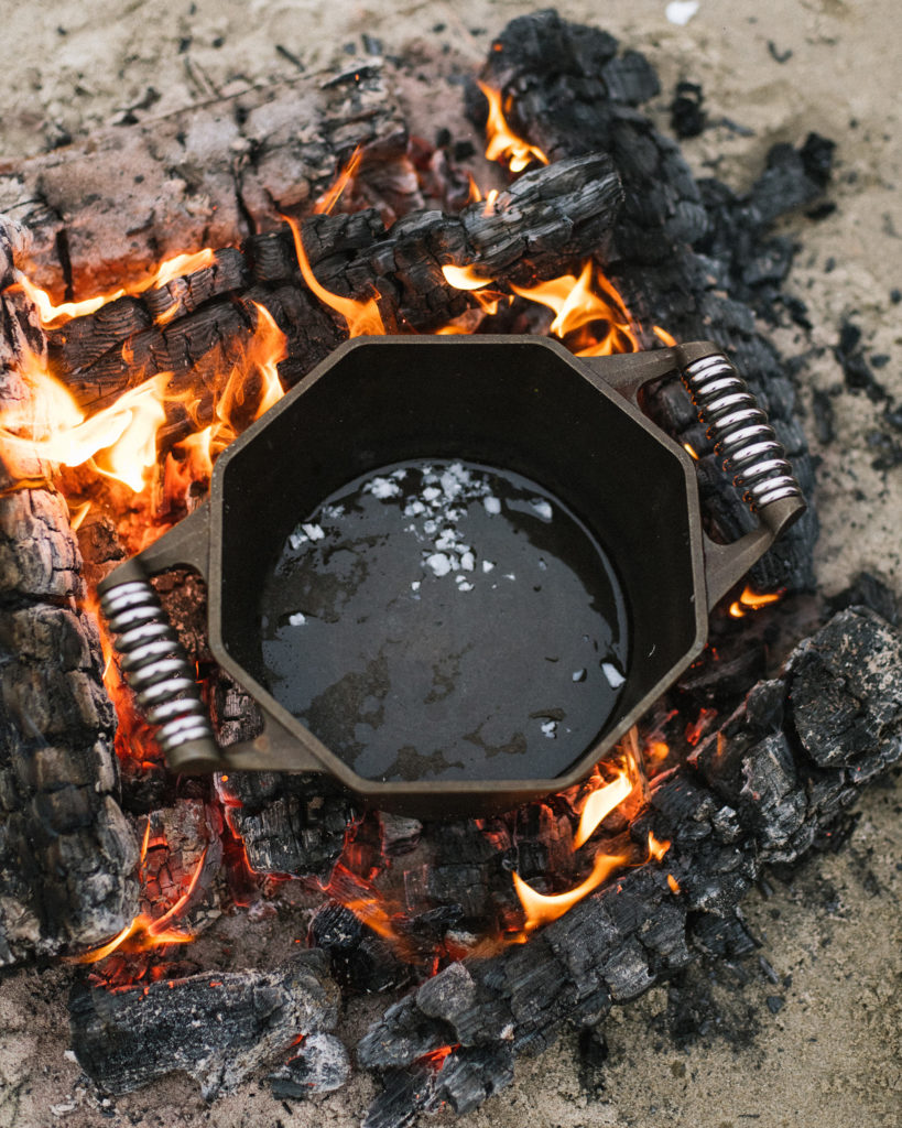 cast iron dutch oven in campfire