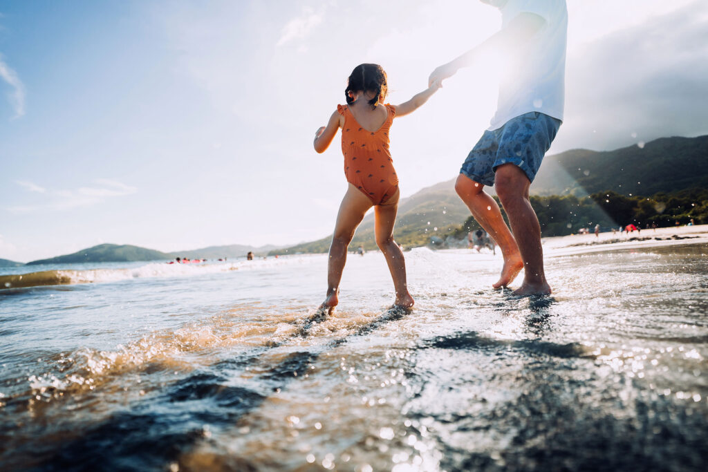 Father and Daughter Playing on Beach