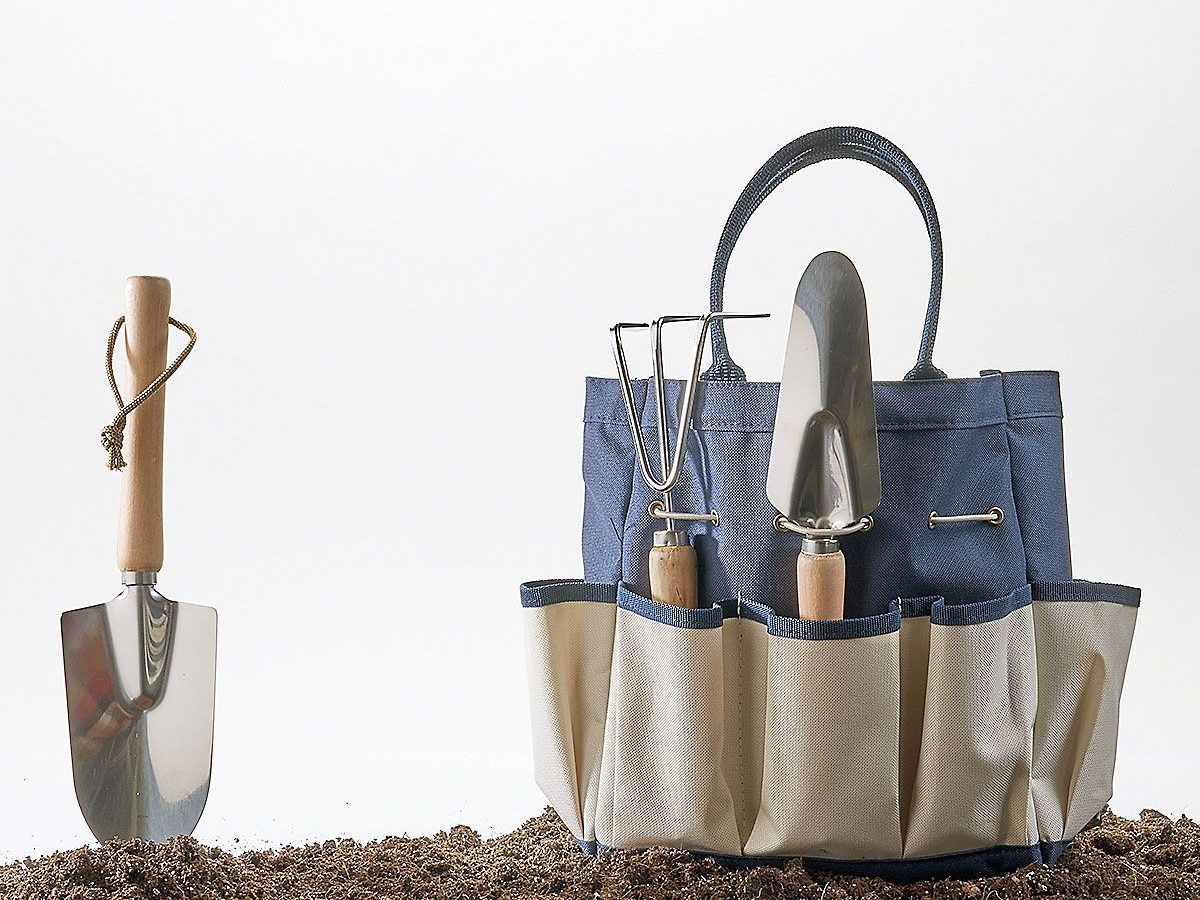 sunset shop garden tote with tools in dirt on white