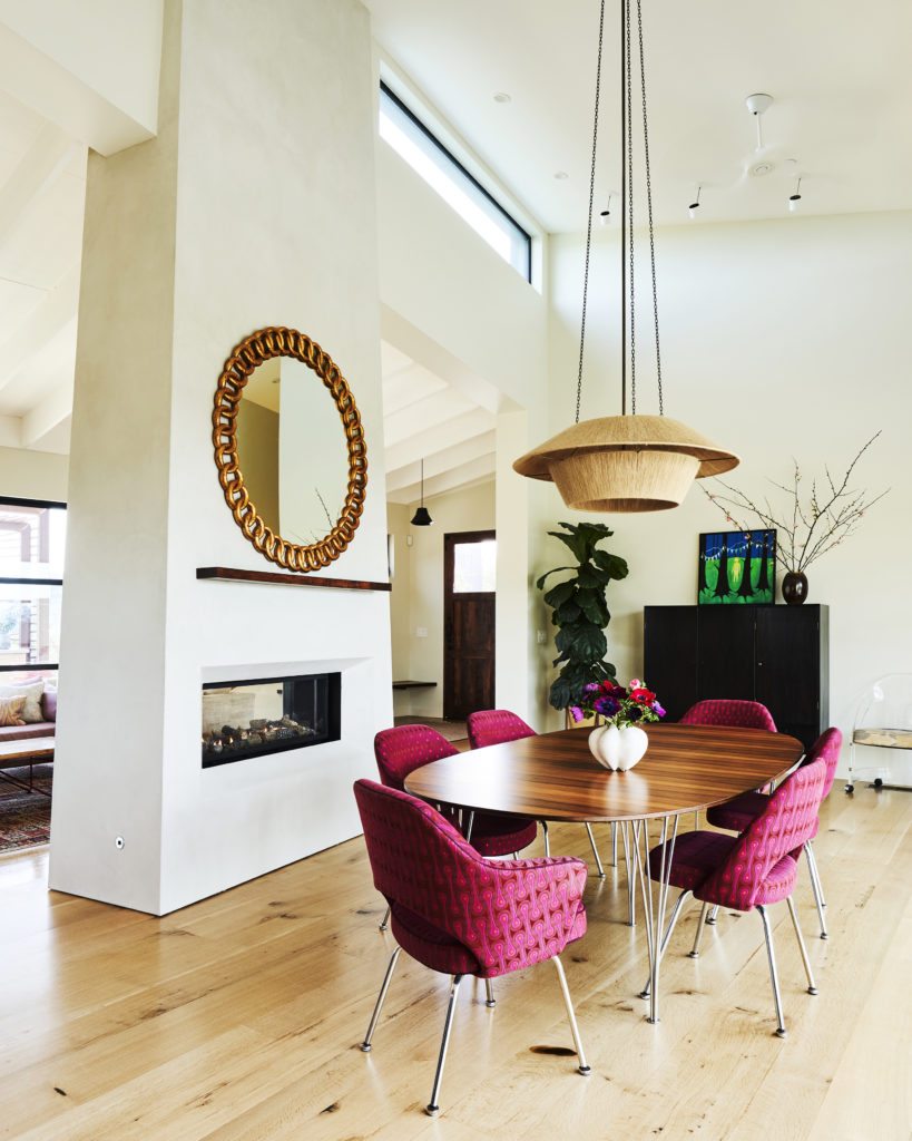 California home dining room table and pink chairs with light pendant