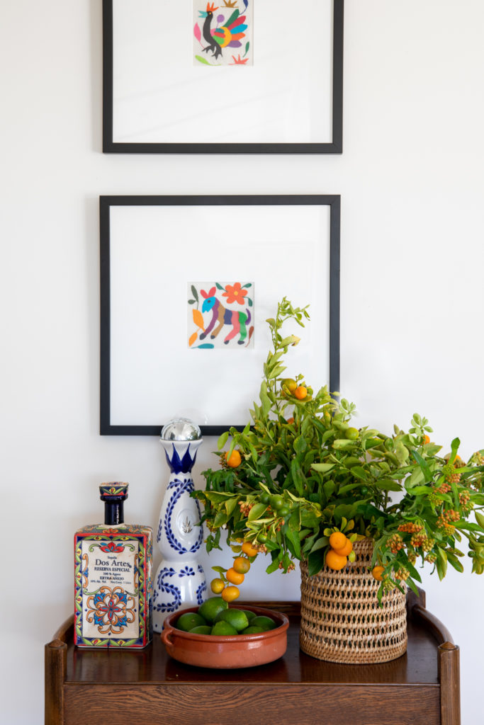 framed Mexican folk art fabric over a vintage bar