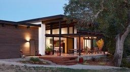 Klopf Architecture in Sacramento designed this single-story modern house with intense summer heat in mind, building a patio under the shade of a mature oak with a large overhang.