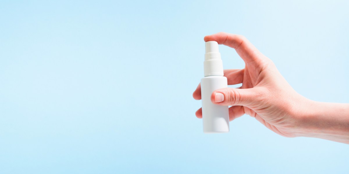 Hand holding spray bottle