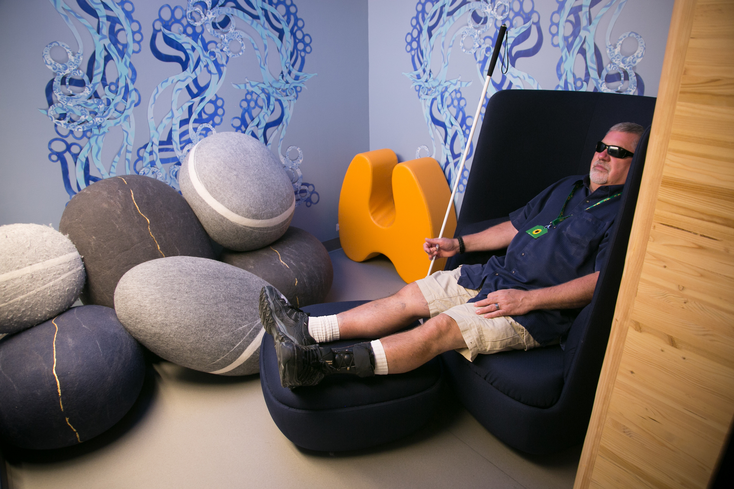 a-traveler-wearing-a-sunflower-lanyard-relaxes-in-the-sensory-room-at-sea