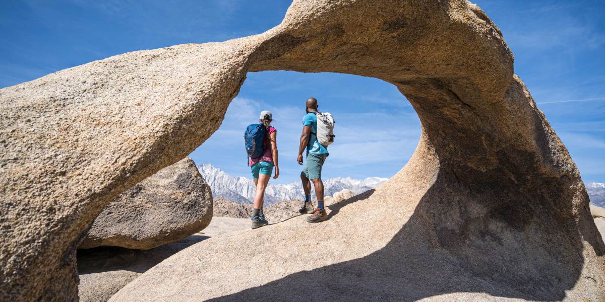 Hikers Under a Sandstone Arch