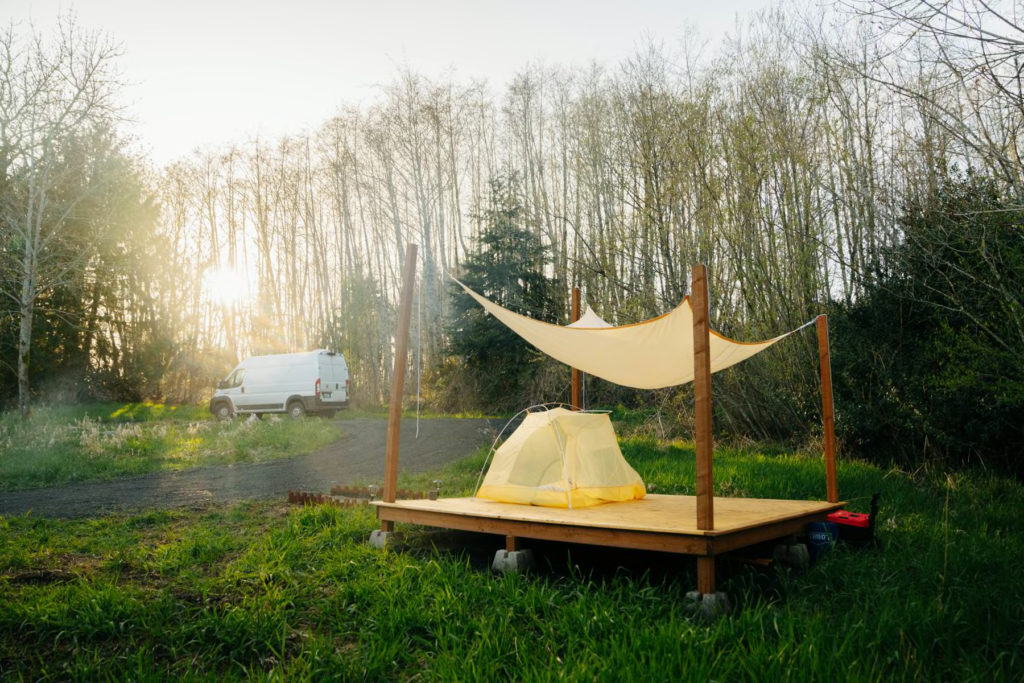 tent on platform in meadow