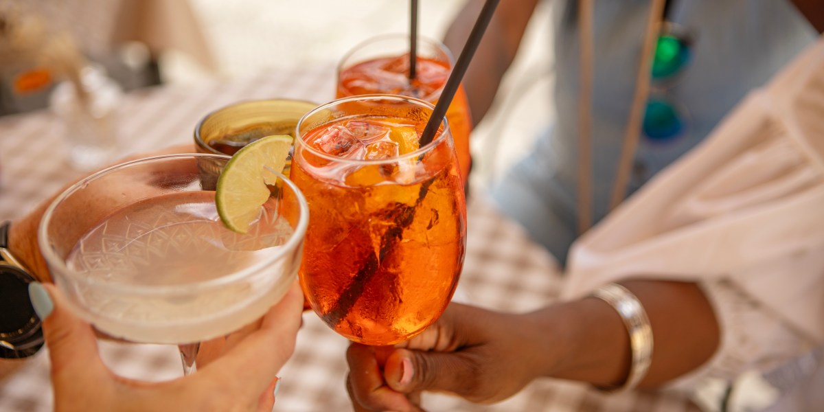 People toasting with different mocktails in hand.