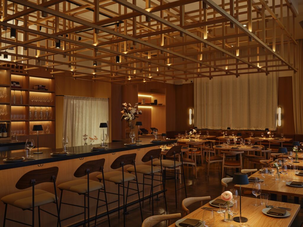 A dimly lit restaurant with a bar and wooden dining tables.