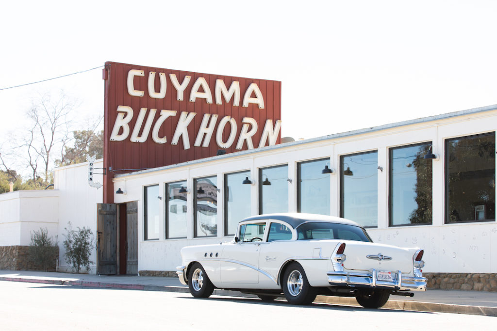 A classic car parks in front of Cuyama Buckhorn in Central California