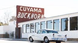 A classic car parks in front of Cuyama Buckhorn in Central California