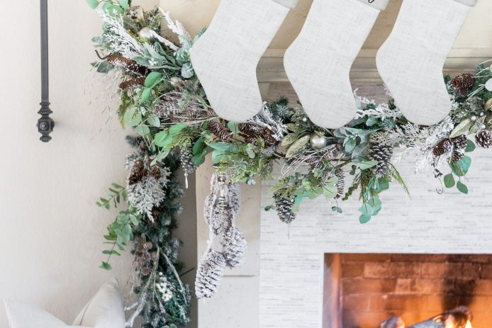 personalized white stockings hanging from mantle
