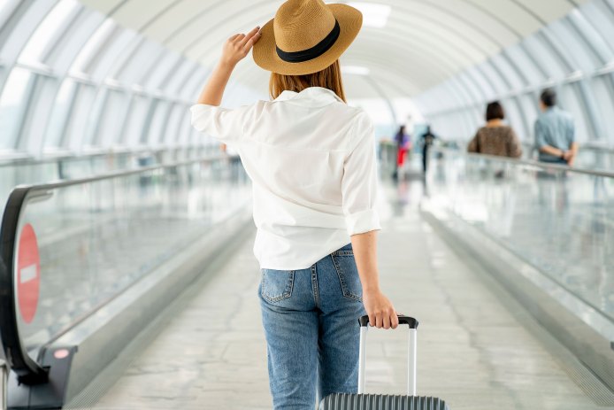 Woman at Airport with Suitcase