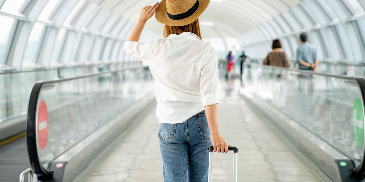 Woman at Airport with Suitcase