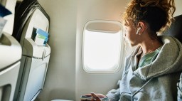 Woman Looking Out Airplane Window